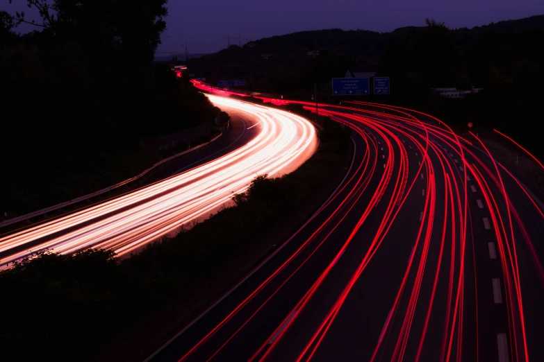 some cars driving on a busy highway and blurry traffic