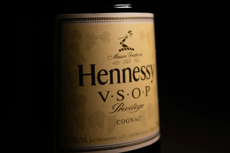 a bottle of hennessosa sv - o - p whiskey on a black table