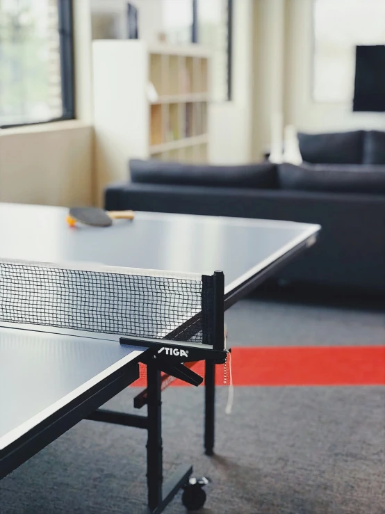 a table tennis table with rackets and ball on it