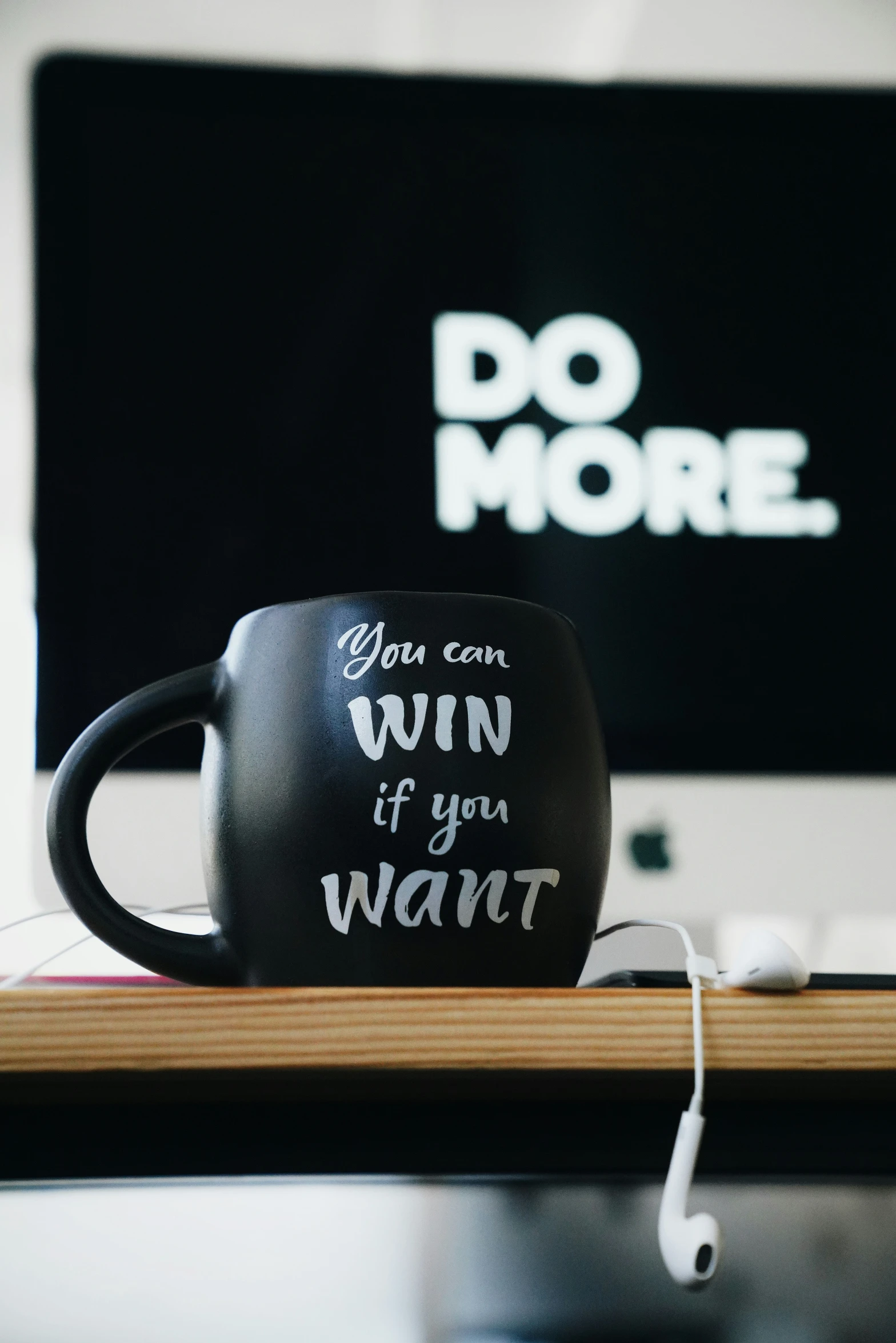 a coffee cup sits next to a computer