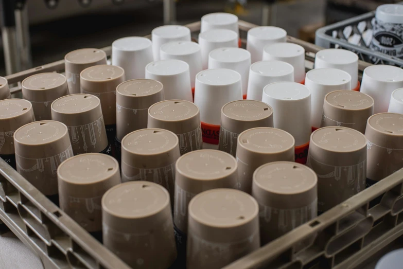 a large tray full of bottles filled with different colored tubes