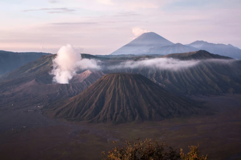 smokey, cloud covered mountain slopes with mountains in the distance