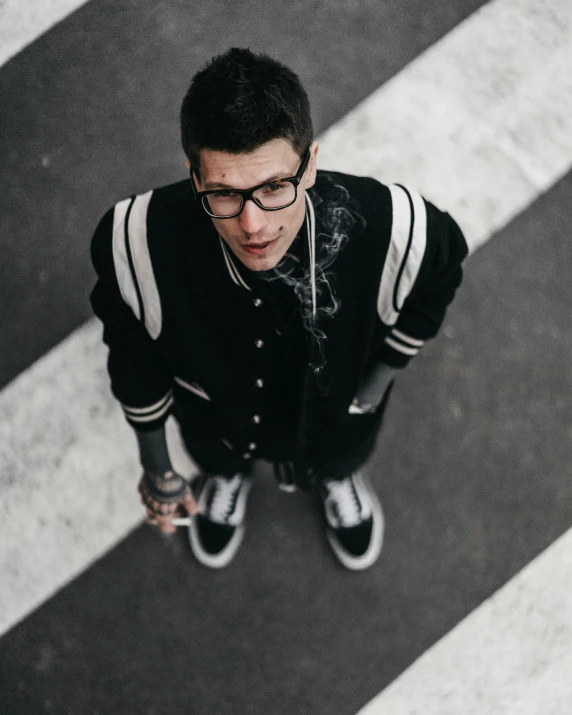 a person standing on the street smoking a cigarette