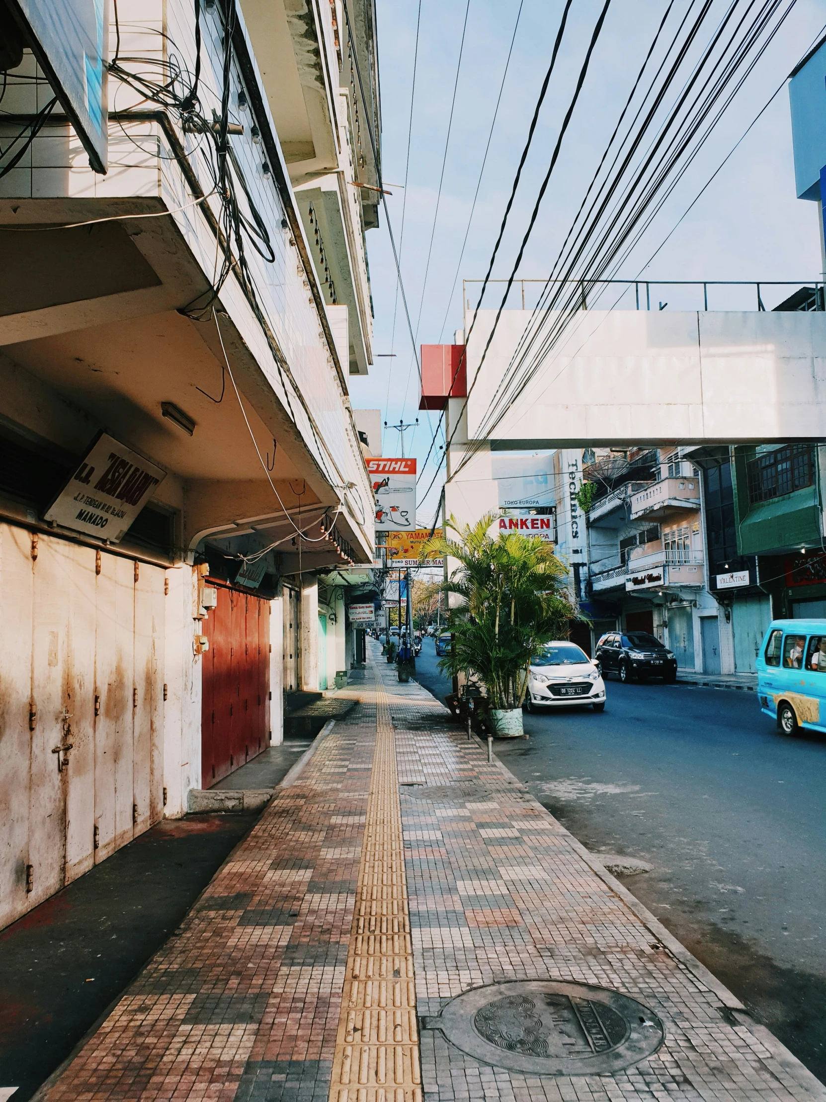 a narrow city street filled with lots of traffic