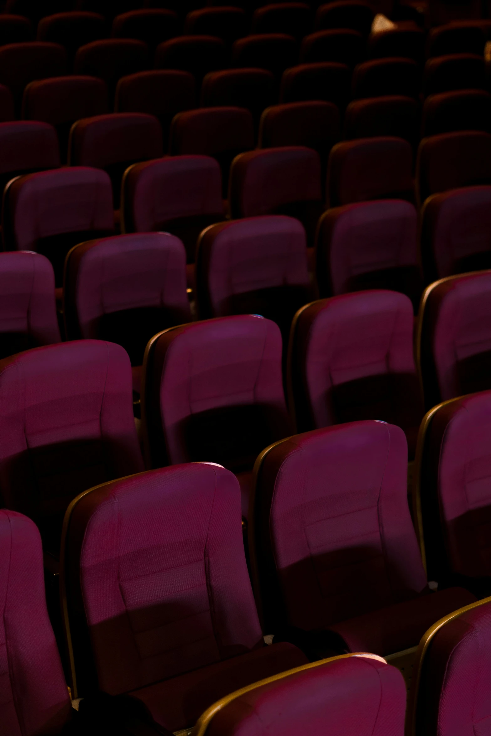 an empty auditorium with a row of empty seats