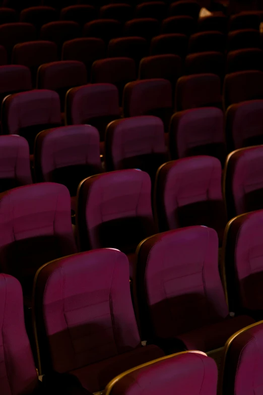 an empty auditorium with a row of empty seats