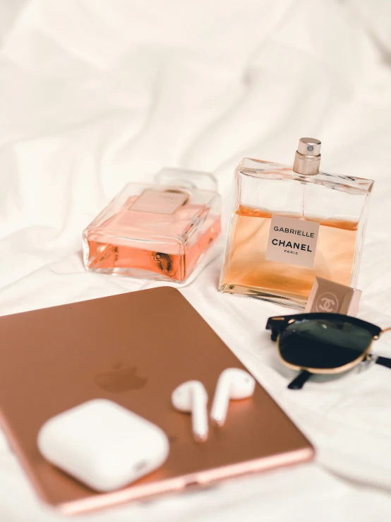 a bottle of chanel next to a pair of glasses on top of a table