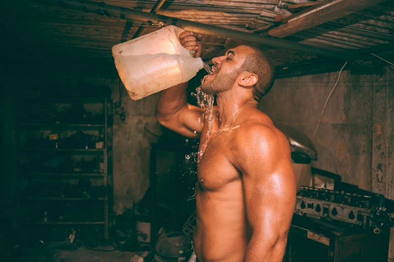 a  man stands in a room holding a bucket