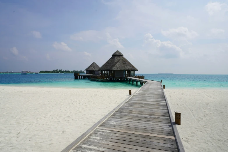 an island with huts on it with white sand