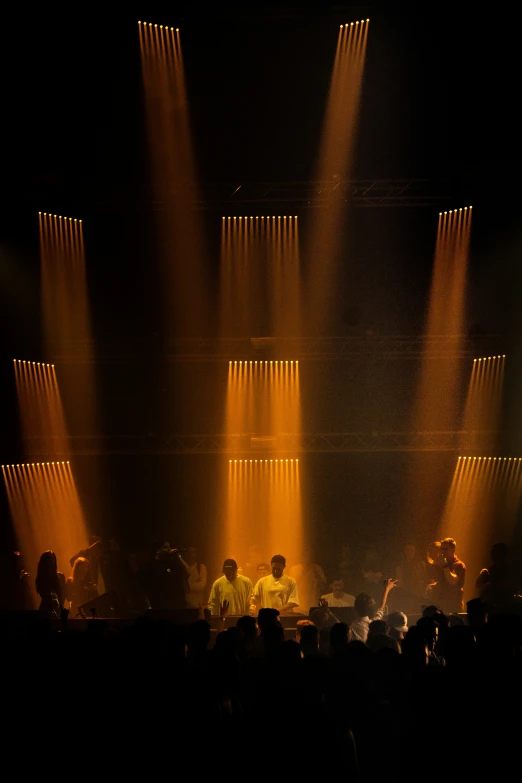 a band plays on stage as bright spotlights illuminate them