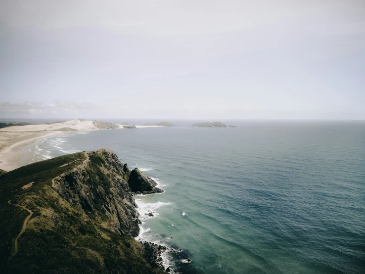 a view of an ocean near some sand dunes