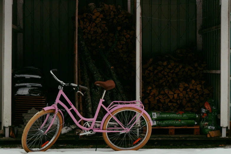 a bicycle parked outside in the snow outside a building