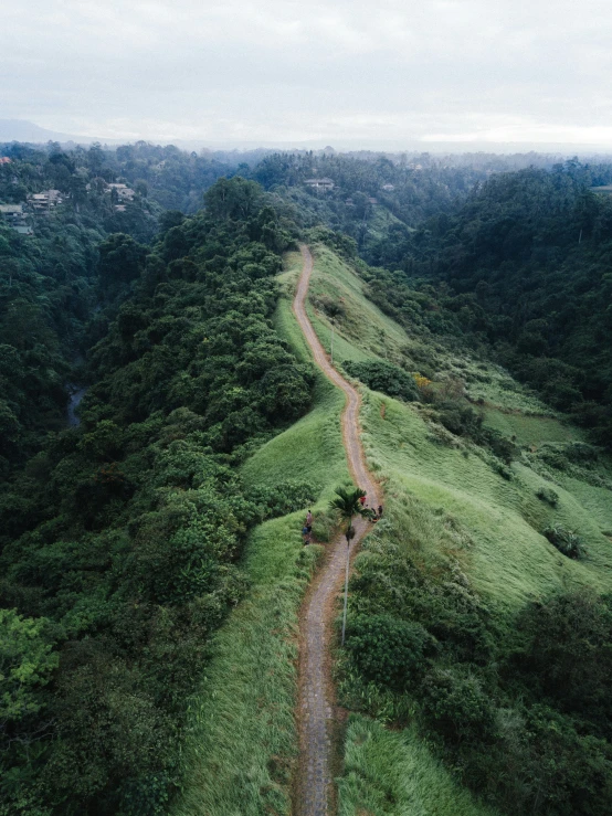 an aerial s of a winding road in the mountains