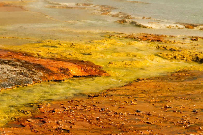 a  springs in a very rocky area with yellow and brown colored substance