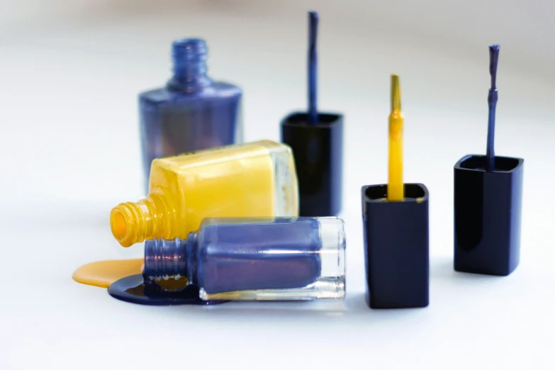 a table with some bottles and containers of nail polish