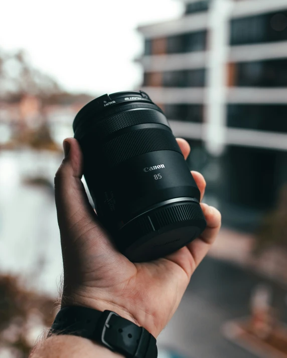 a person holds an electronic camera in their hand