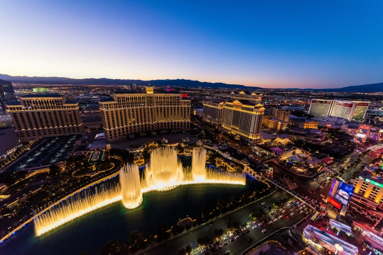 an aerial view of the strip and the fountains at night