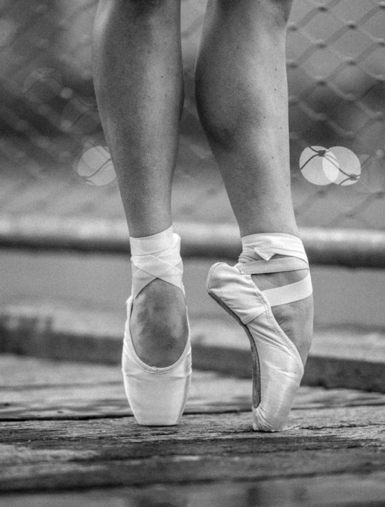 the feet and ankles of a woman with shoes