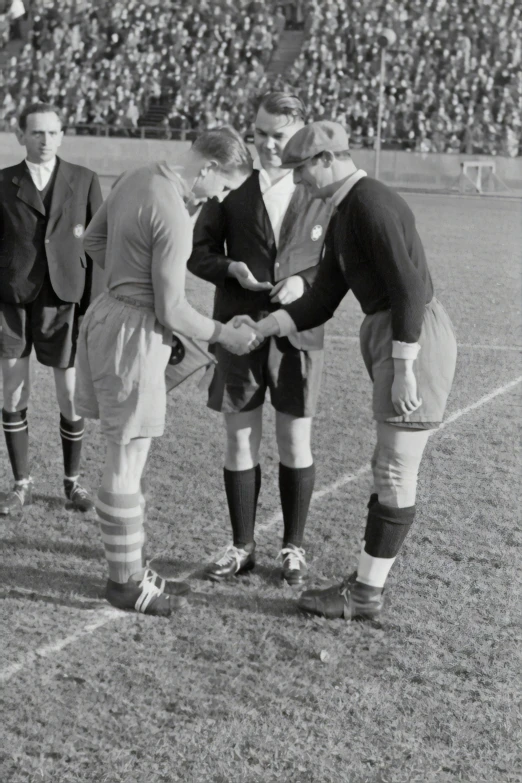 an old po of a man talking to two men in uniform