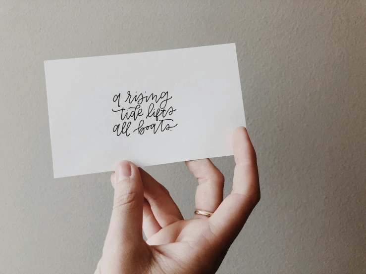 a person holding an envelope with handwritten quote