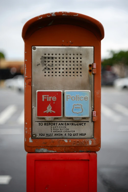 an old public phone booth with emergency on