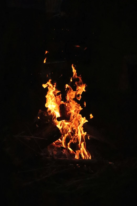 a group of flames burning on top of a dark floor