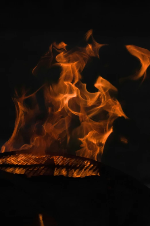 an orange fire with orange smoke trails over it