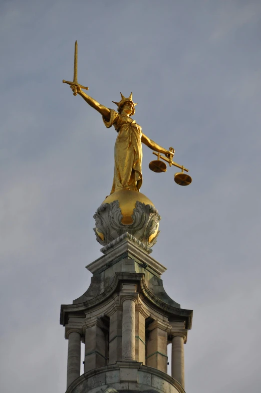the statue of lady justice holds an iron scale