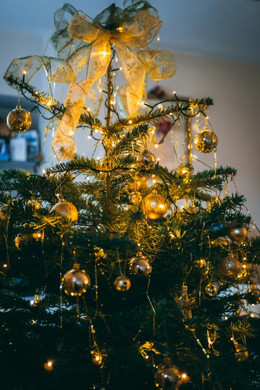 a christmas tree covered in baubles and yellow lights