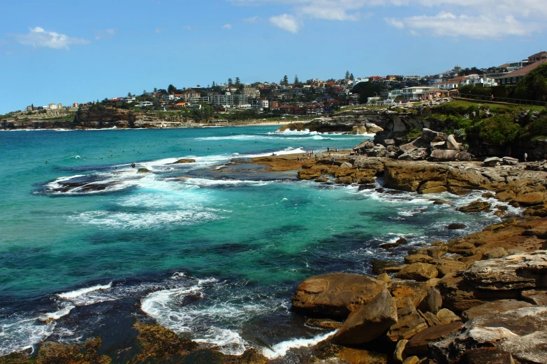 the view from the cliff is looking at the water and rocky shore