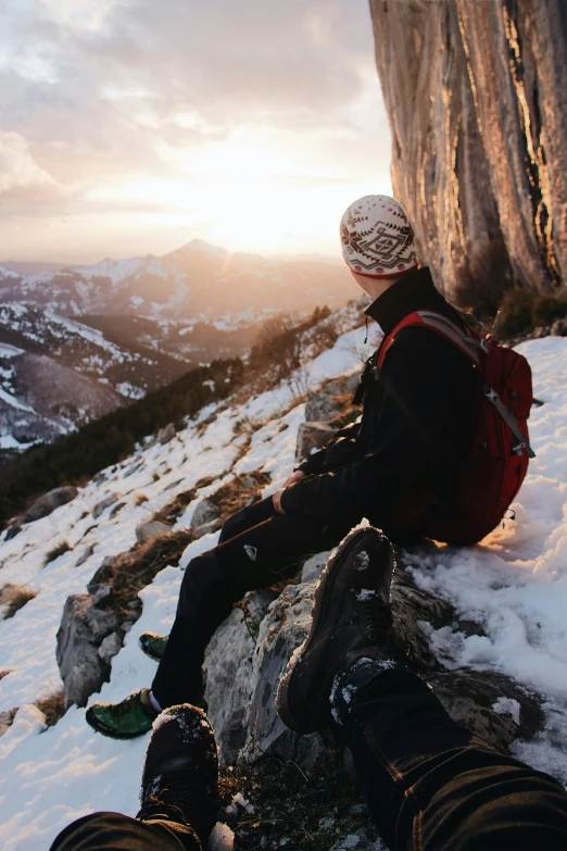 a person sitting on top of snow covered ground