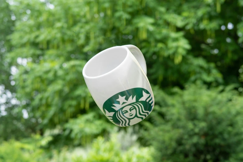 starbucks logo coffee mug with a view of trees