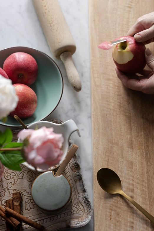 someone making miniature apples in small ceramic dishes