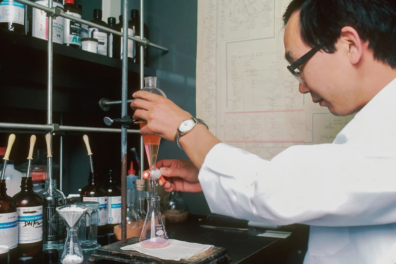 man doing soing in a glass at a counter