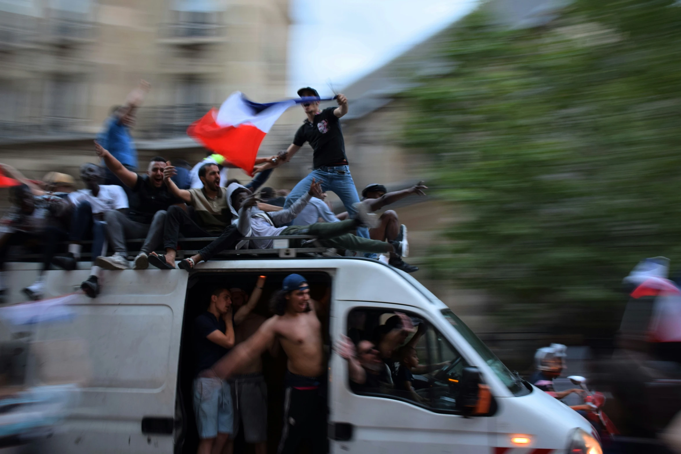 a white truck with people riding on top of it