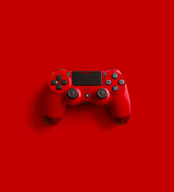 a video game controller on red background