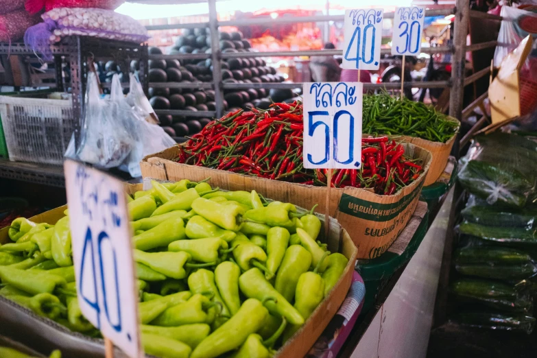 vegetable stands with numbered signs for sale at the market