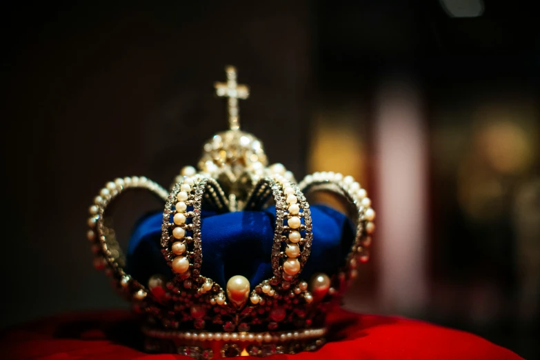 a blue crown with a cross on it