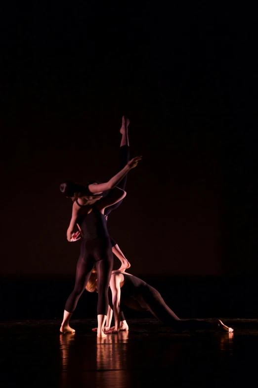 three dancers in motion, standing in the middle