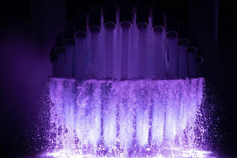 a water fountain spewing purple from the ground