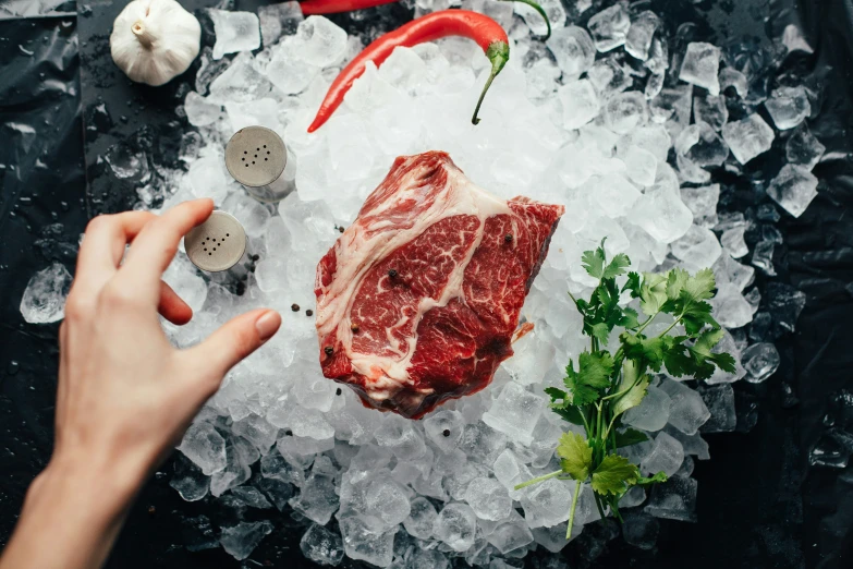 someone slicing up the top of their steak on ice