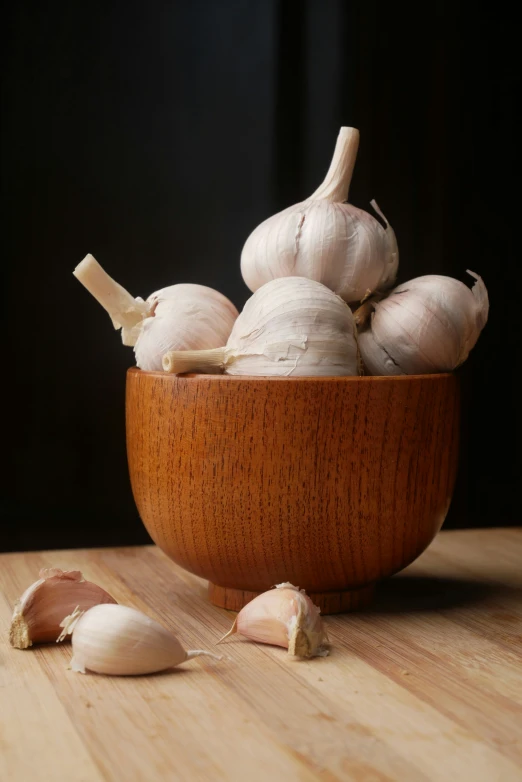 garlic cloves and garlic bulbs are sitting on a table