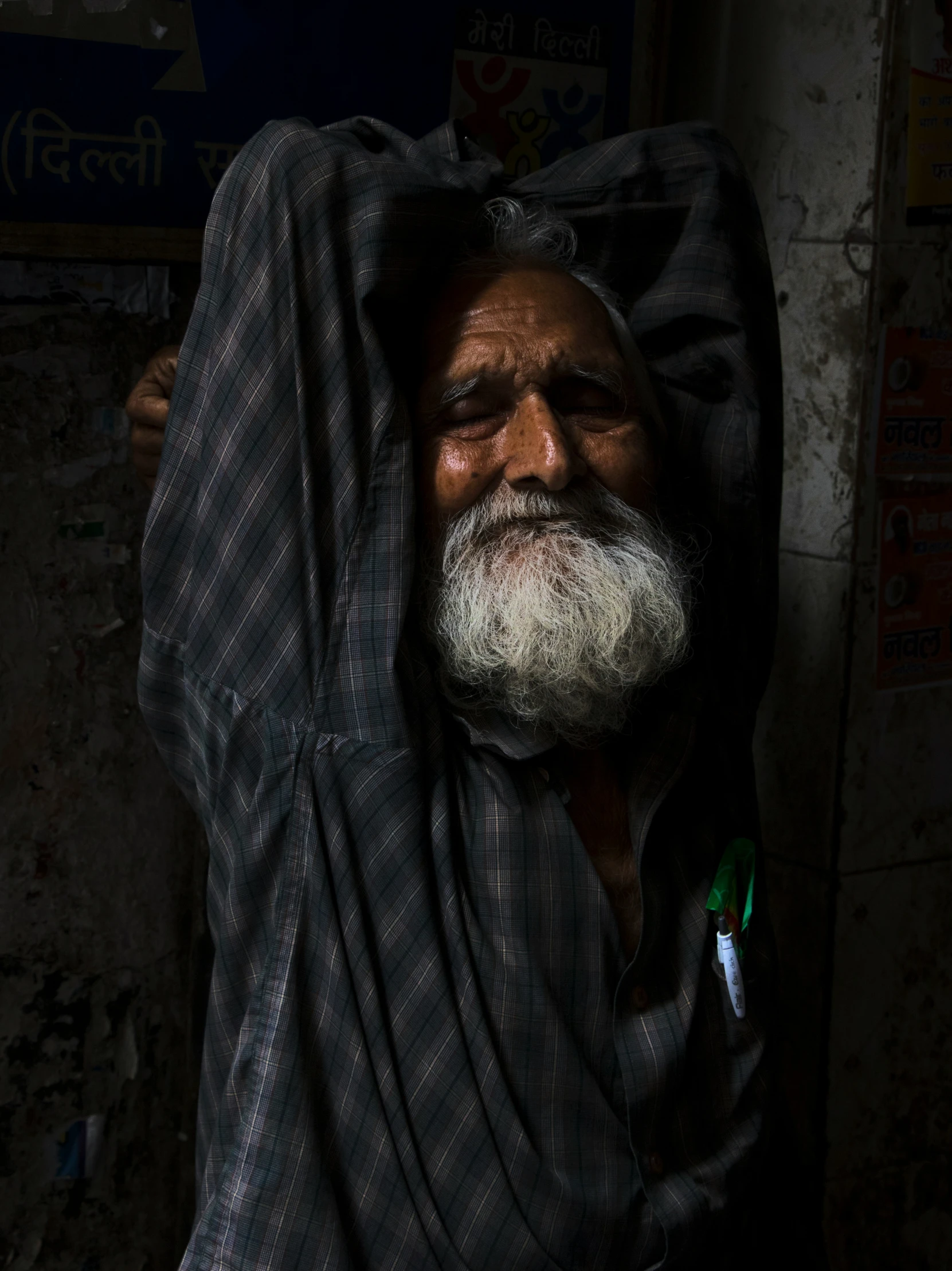 a man is covered by his blanket with no hair