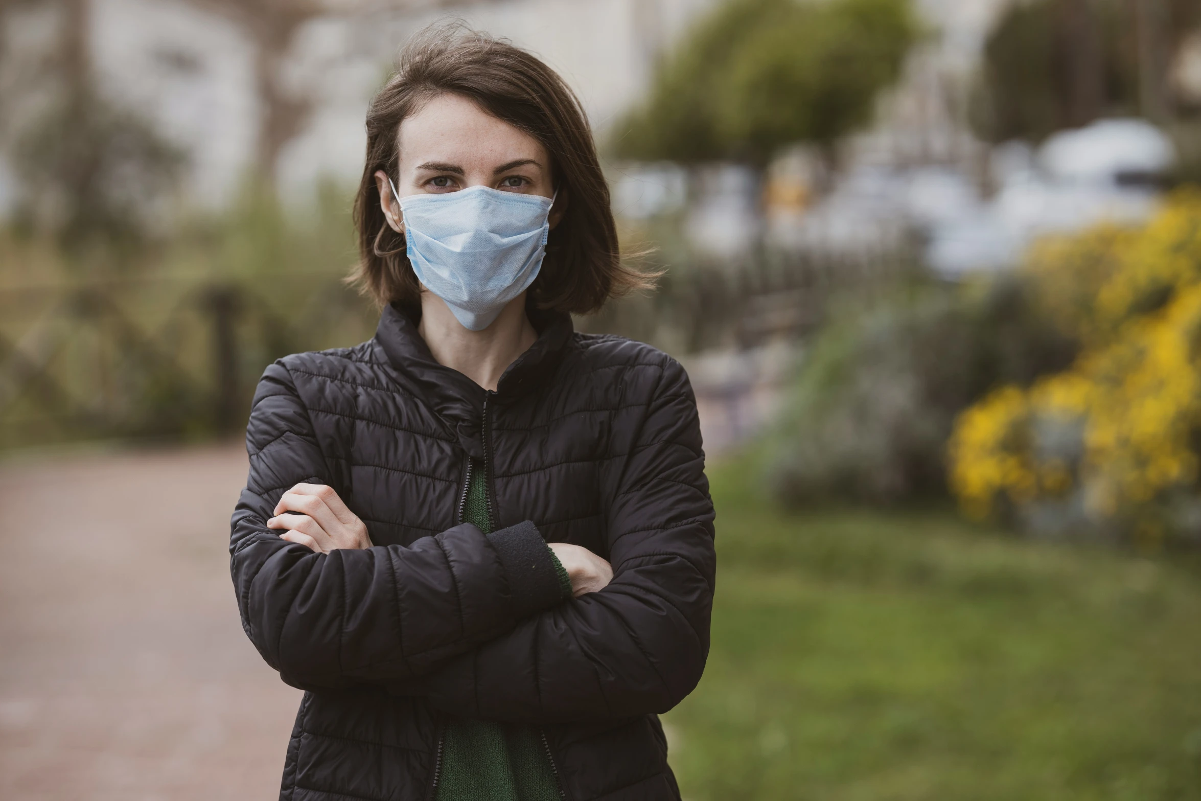 a person wearing a mask is standing in front of a road