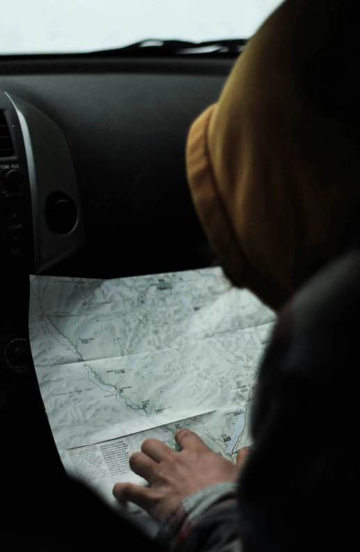 a man reading a map in his car