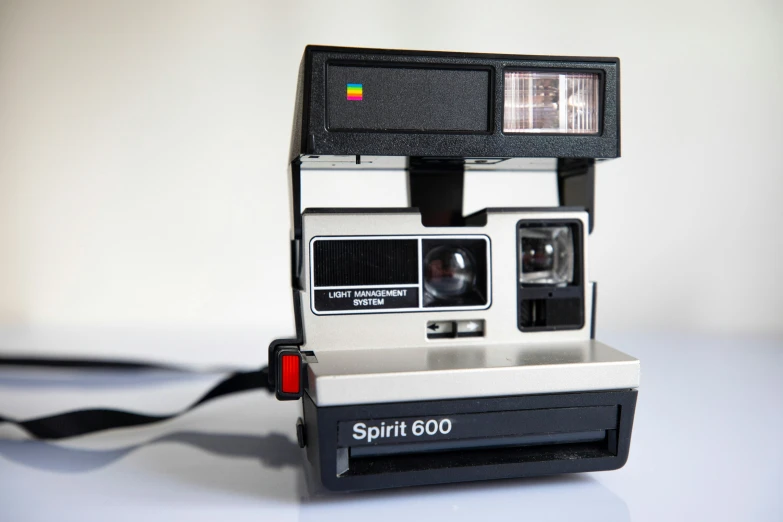 a small polaroid camera with its lens open