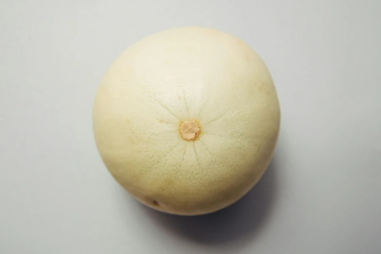 an orange on a table with no one around it