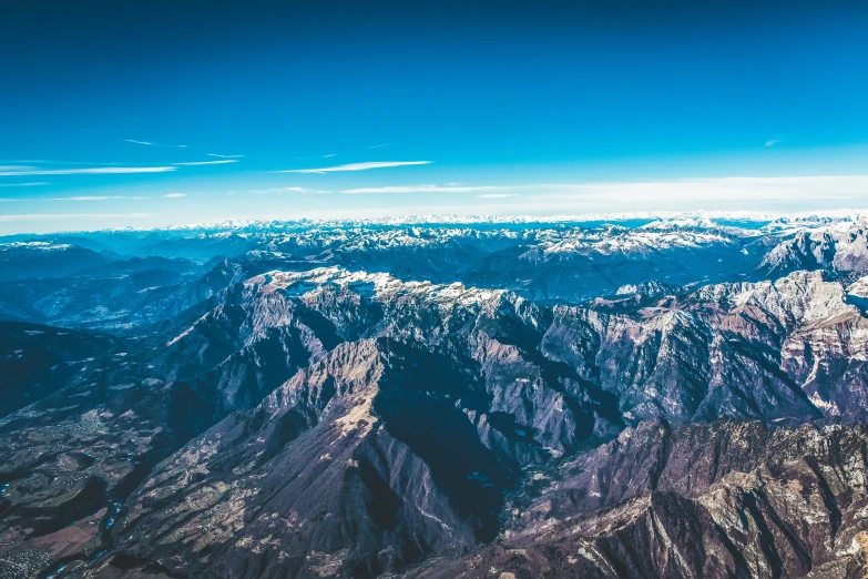 an aerial view of some mountains and the sky