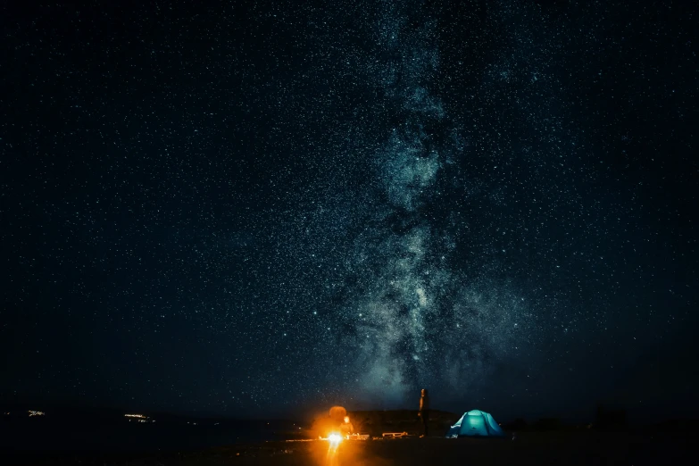 a tent with lights and the milky in the background