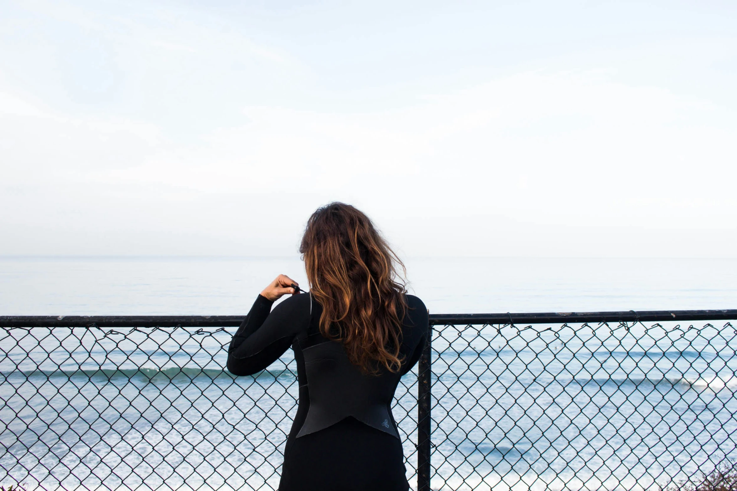 a woman looking out over the ocean and the water